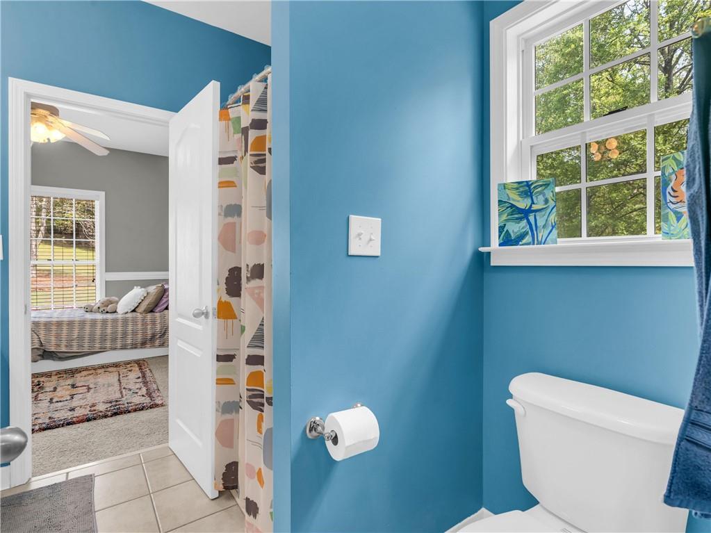 157 Cooks Way McDonough, GA 30252 - Photo 33 of 63 a bathroom with a toilet and a shower curtain