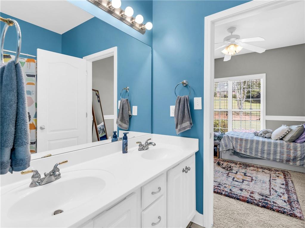 157 Cooks Way McDonough, GA 30252 - Photo 34 of 63 a en suite bathroom with a sink double vanity and a mirror