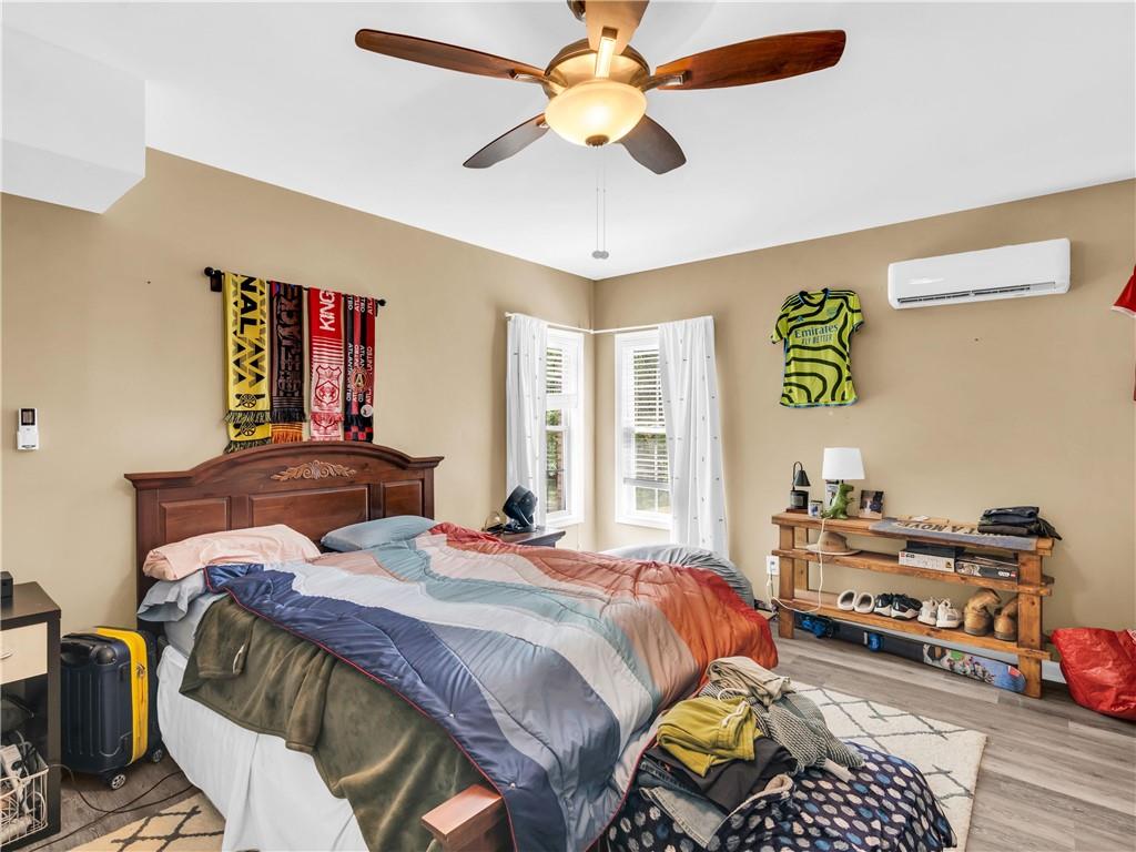 157 Cooks Way McDonough, GA 30252 - Photo 48 of 63 a bedroom with a bed and wooden floor