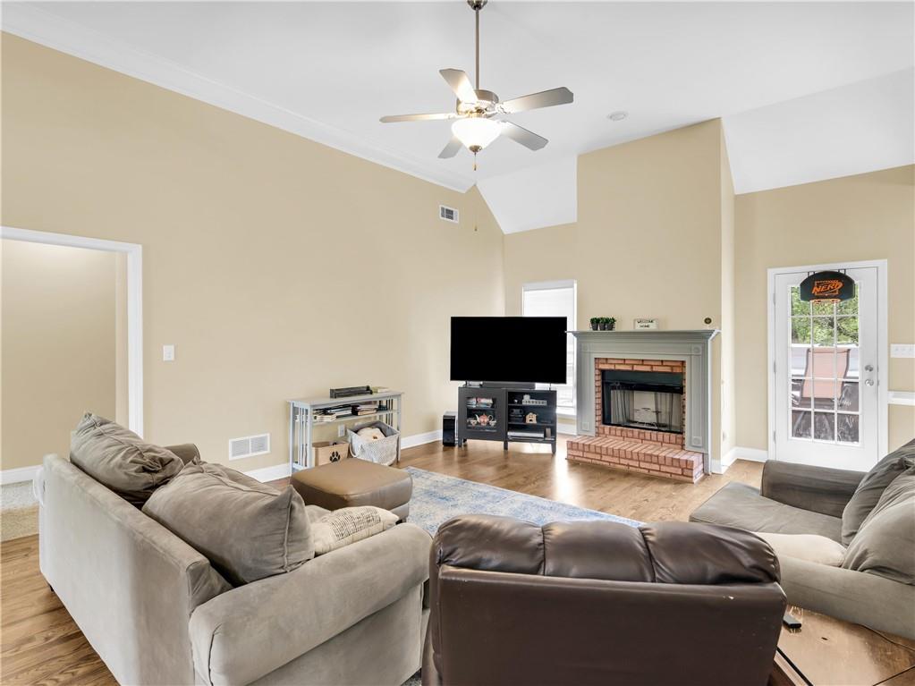 157 Cooks Way McDonough, GA 30252 - Photo 10 of 63 a living room with furniture a fireplace and a flat screen tv
