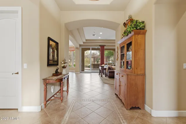 a view of a patio with table and chairs and a large tree
