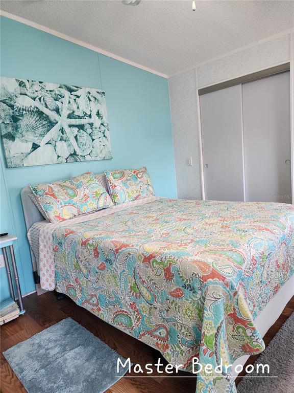 1001 Starkey Road, Unit 758 Largo, FL 33771 - Photo 11 of 20 a bedroom with a bed and painting on the wall