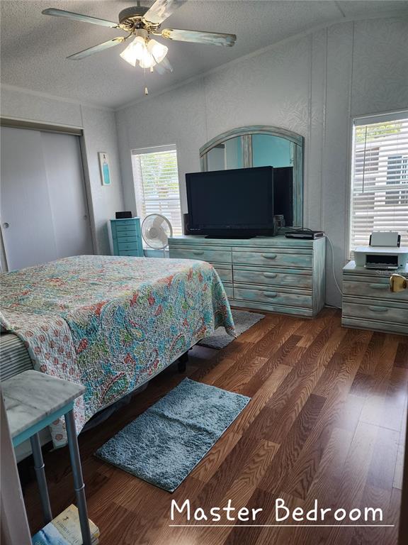 1001 Starkey Road, Unit 758 Largo, FL 33771 - Photo 12 of 20 a bedroom with a bed and a flat screen tv