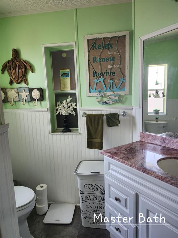 1001 Starkey Road, Unit 758 Largo, FL 33771 - Photo 13 of 20 a bathroom with a toilet a sink and mirror
