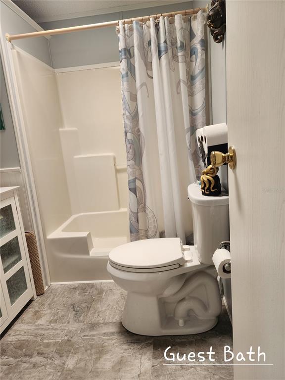 1001 Starkey Road, Unit 758 Largo, FL 33771 - Photo 18 of 20 a bathroom with a toilet and a shower curtain