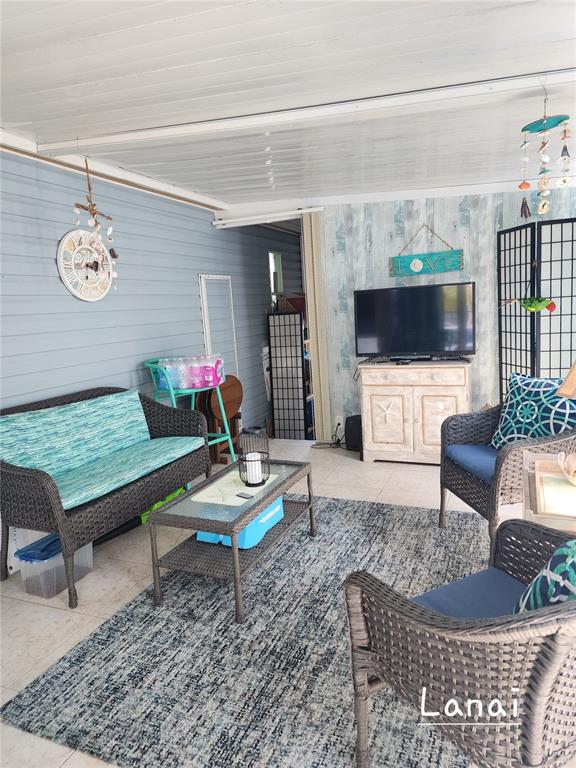 1001 Starkey Road, Unit 758 Largo, FL 33771 - Photo 4 of 20 a living room with furniture and a flat screen tv