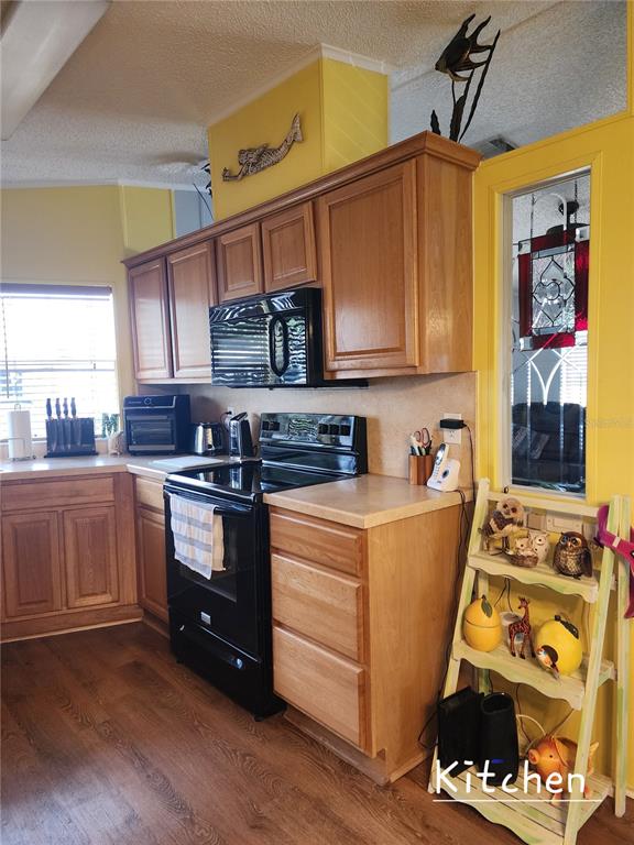 1001 Starkey Road, Unit 758 Largo, FL 33771 - Photo 8 of 20 a kitchen with stainless steel appliances granite countertop a stove and a refrigerator