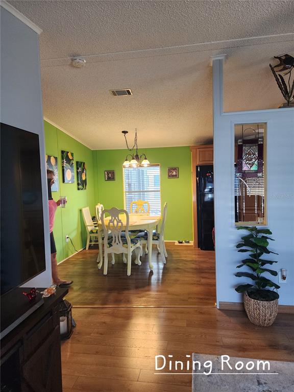 1001 Starkey Road, Unit 758 Largo, FL 33771 - Photo 10 of 20 a view of a dining room with furniture and a flat screen tv