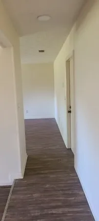 a view of a room with wooden floor