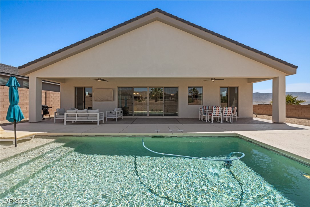 1357 Manassas Ridge Mesquite, NV 89027 - Photo 51 of 72 View of swimming pool featuring ceiling fan, a patio, and an outdoor living space