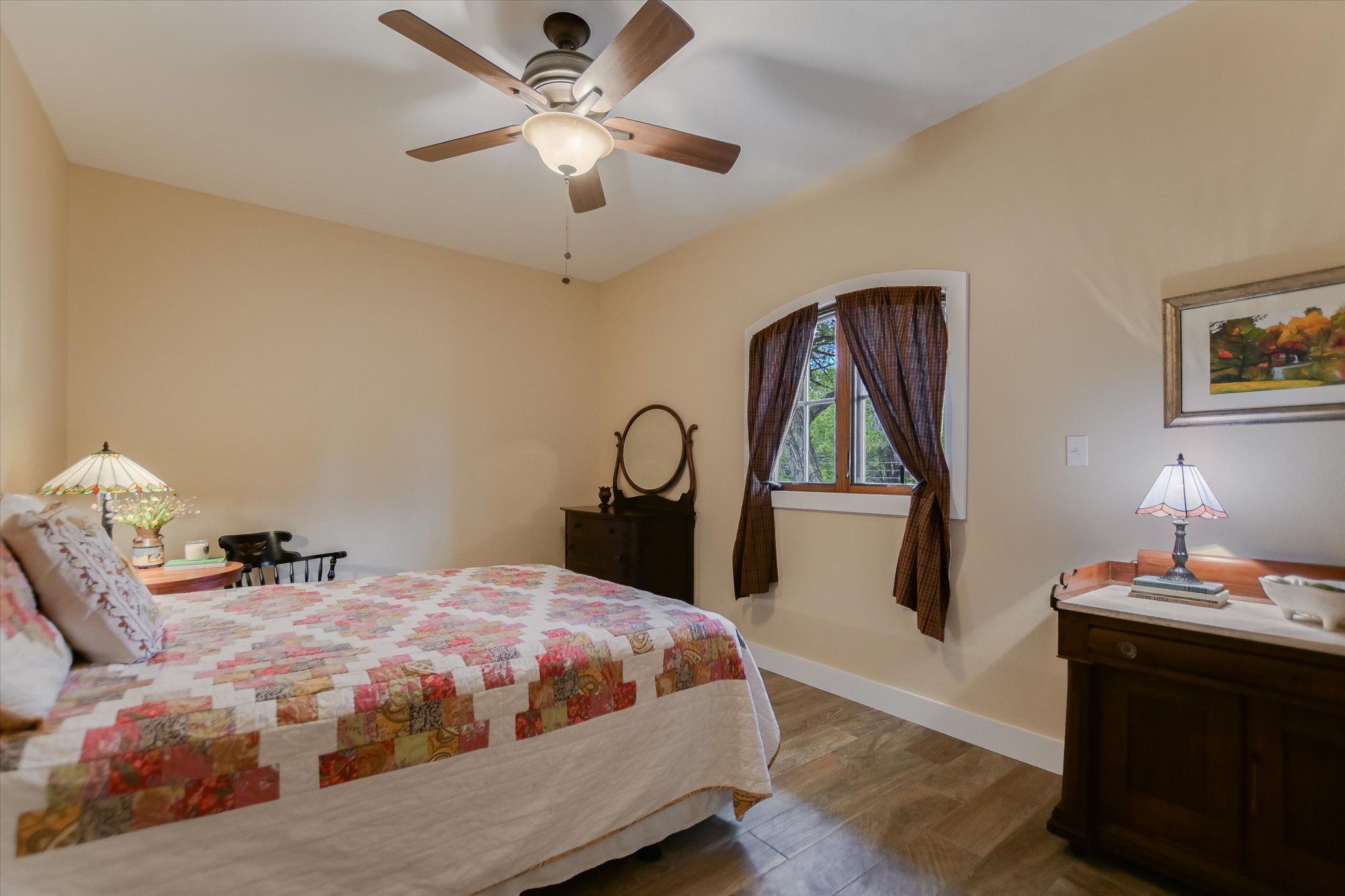 590 Rancho Grande Drive Wimberley, TX 78676 - Photo 22 of 30 a bedroom with a bed and a chandelier