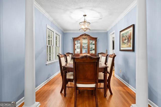 a view of a dining room with furniture window and wooden floor