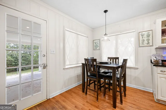 a view of a dining room with furniture window and wooden floor