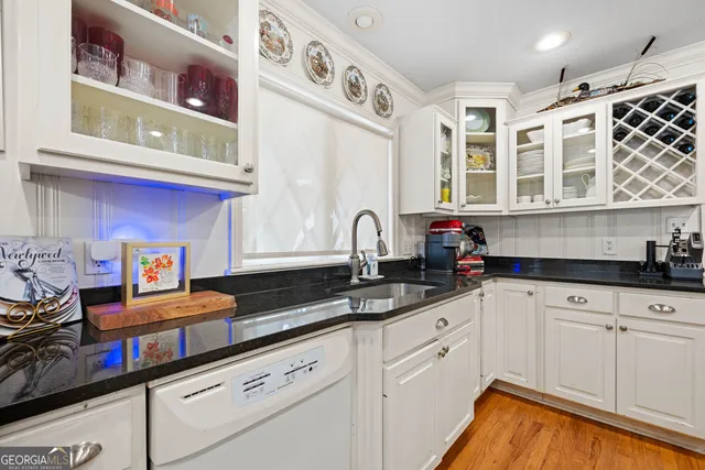 a kitchen with stainless steel appliances granite countertop a sink and cabinets