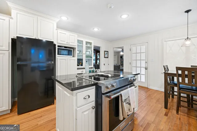 a kitchen with stainless steel appliances granite countertop a stove and a refrigerator