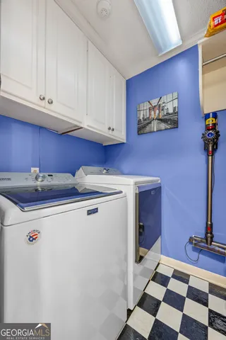 a kitchen with a refrigerator sink and cabinets