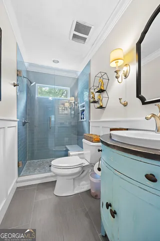 a bathroom with a sink mirror vanity and toilet