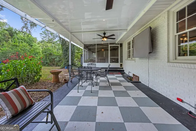 a table and chairs in a patio of the house