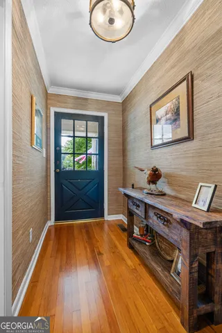 a view of a livingroom with furniture wooden floor and window