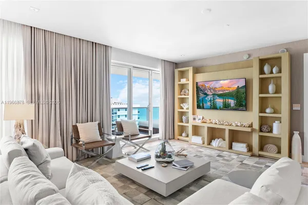 a living room with furniture a rug and a large window