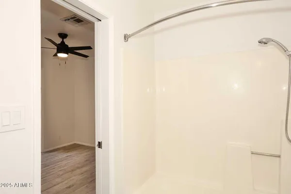 a bathroom with a window and a shower