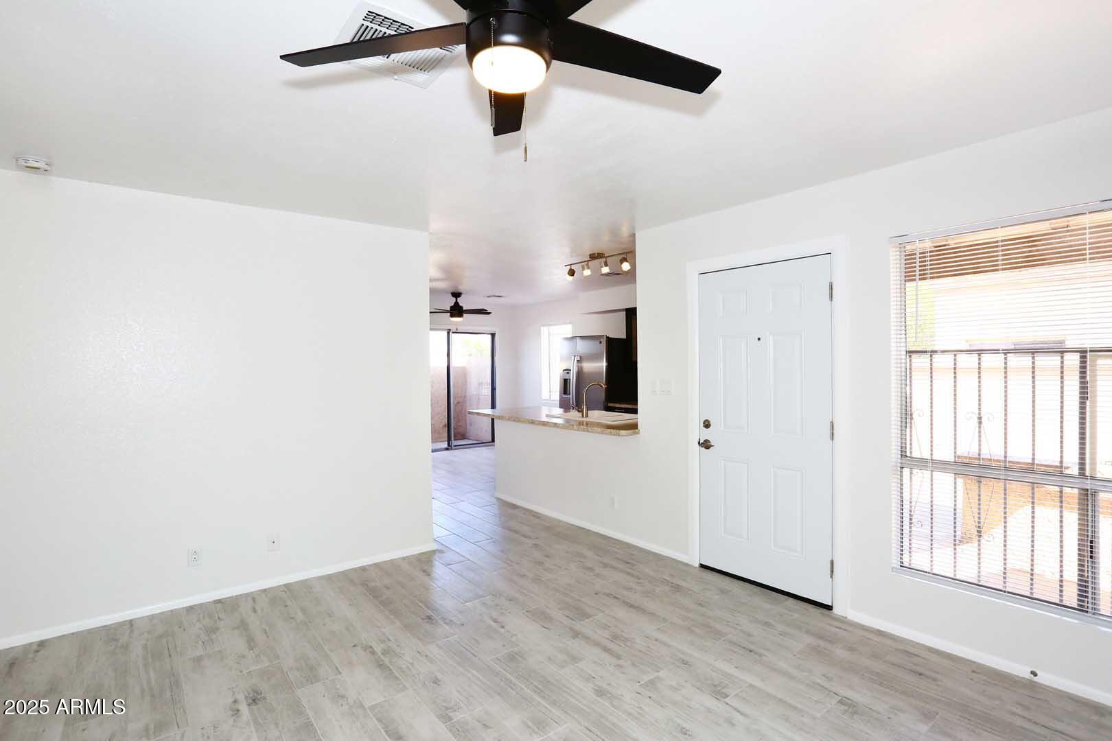 93 North Cooper Road, Unit 32 Chandler, AZ 85225 - Photo 3 of 33 wooden floor in an empty room with a window