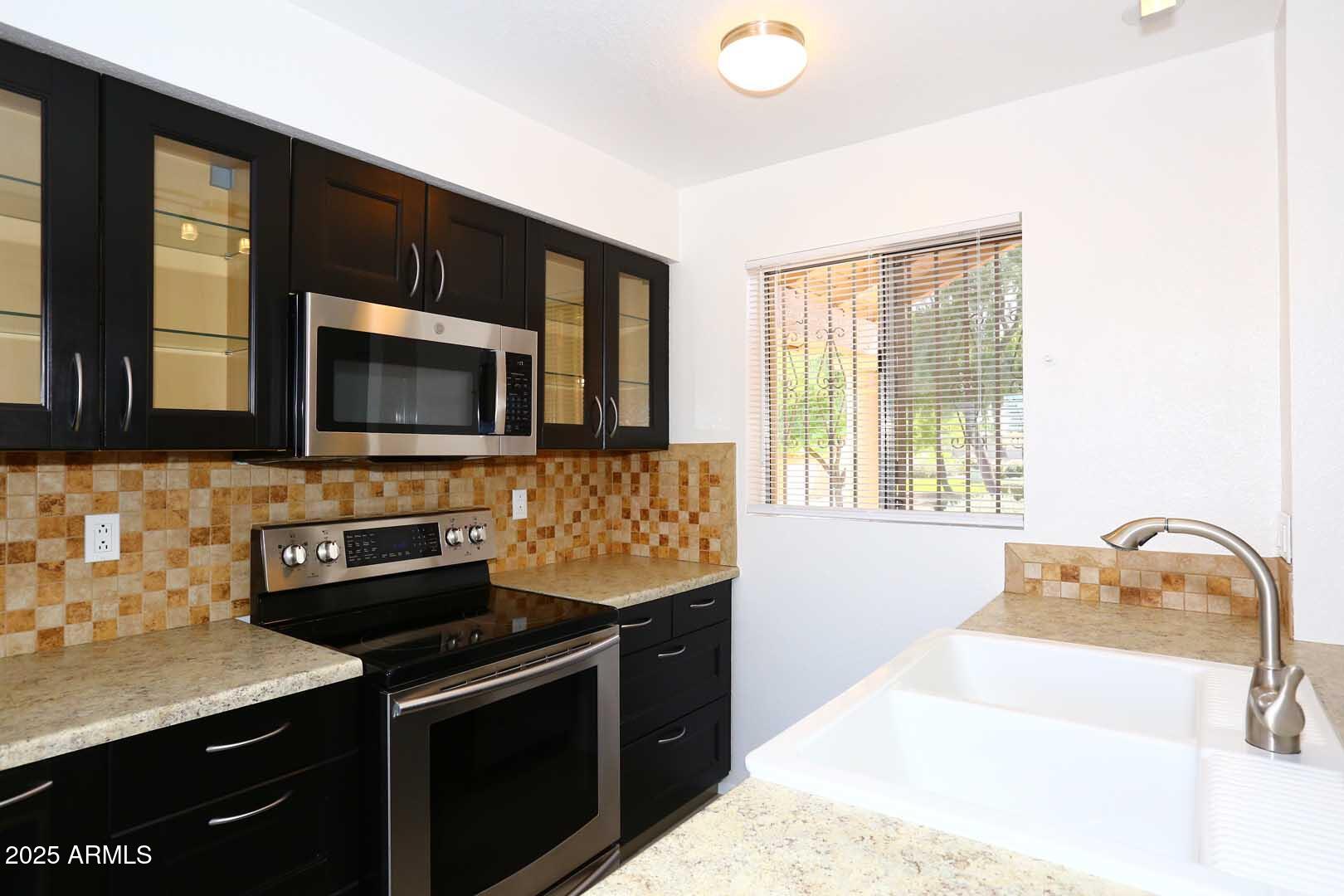 93 North Cooper Road, Unit 32 Chandler, AZ 85225 - Photo 5 of 33 a kitchen with a sink stove and microwave