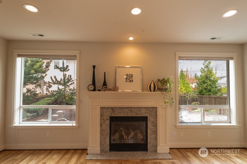 3825 221st Place Southeast Bothell, WA 98021 - Photo 14 of 40 a living room with a fireplace and windows