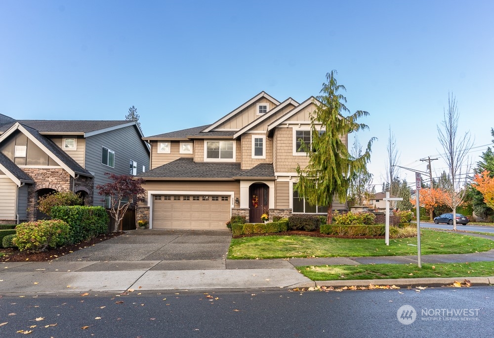 3825 221st Place Southeast Bothell, WA 98021 - Photo 2 of 40 a front view of a house with a yard and trees