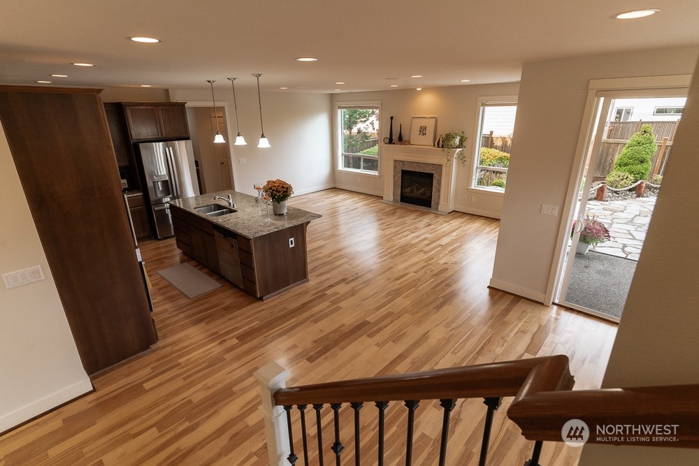 3825 221st Place Southeast Bothell, WA 98021 - Photo 22 of 40 a kitchen with stainless steel appliances granite countertop a refrigerator a sink dishwasher a stove and white countertops with wooden floor