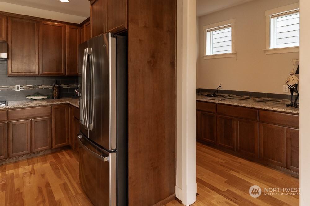 3825 221st Place Southeast Bothell, WA 98021 - Photo 24 of 40 a kitchen with a refrigerator a sink and cabinets