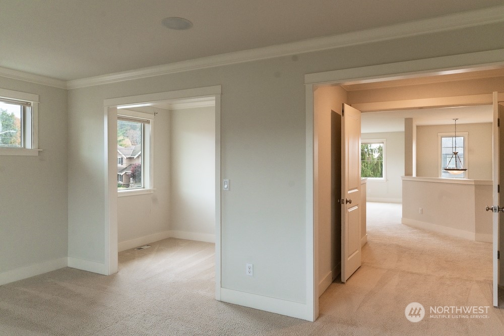 3825 221st Place Southeast Bothell, WA 98021 - Photo 37 of 40 a view of a hallway with wooden floor and a living room
