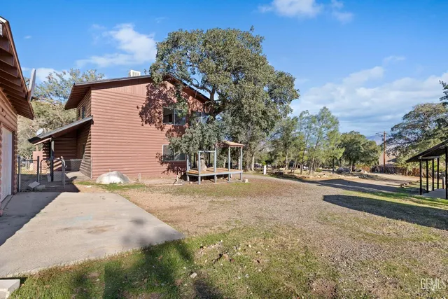 a view of a house with a yard and garage