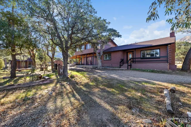 a view of a house with a yard covered in snow