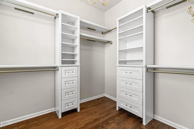 a view of walk in closet with empty racks