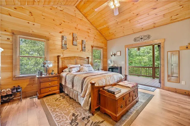 a spacious bedroom with a bed and wooden floor