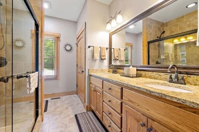 a bathroom with a granite countertop sink mirror and double