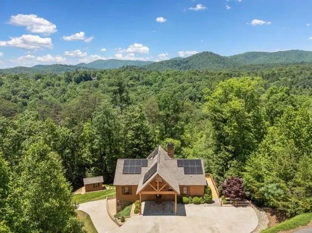 a view of a house with a yard and mountain