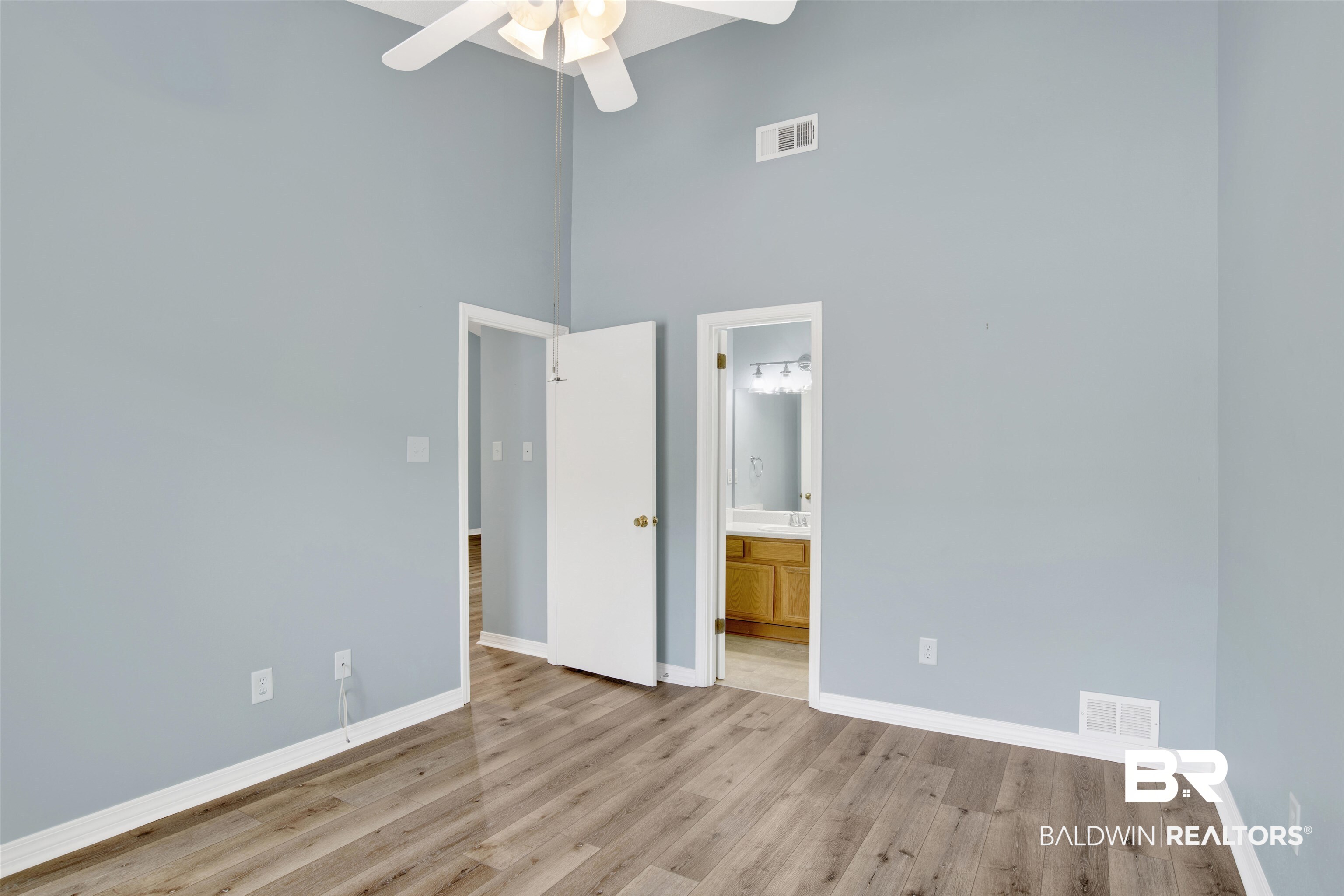 1258 Sutton Court, Unit 4 Mobile, AL 36609 - Photo 11 of 19 Unfurnished bedroom with visible vents, baseboards, and a high ceiling
