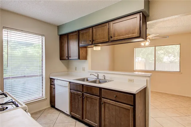 a utility room with cabinets washer and dryer
