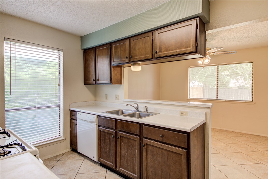 12012 Swallow Drive Austin, TX 78750 - Photo 12 of 33 a utility room with cabinets washer and dryer