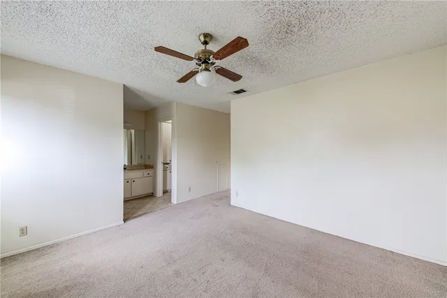 a view of a room with a ceiling fan and a window