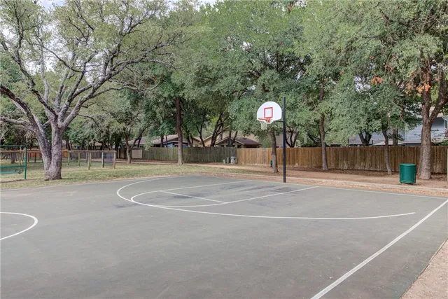 a view of a playground with basketball court