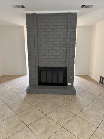 a view of an empty room with a fireplace