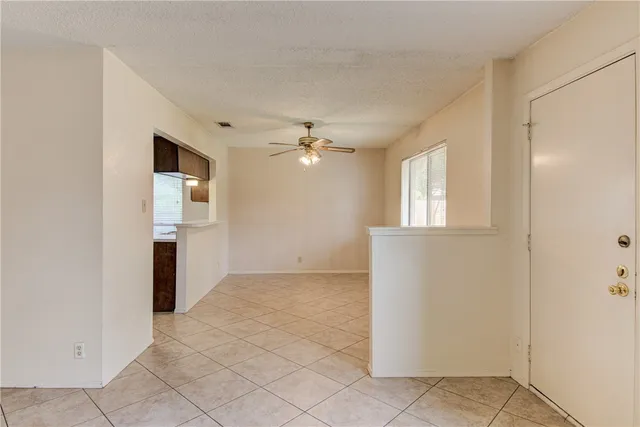 an empty room with windows and cabinet