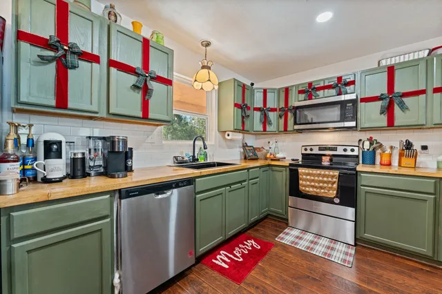 a kitchen with a sink cabinets and a window