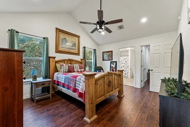 a bedroom with a bed and wooden floor