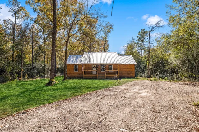 a view of a house with a yard and tree s
