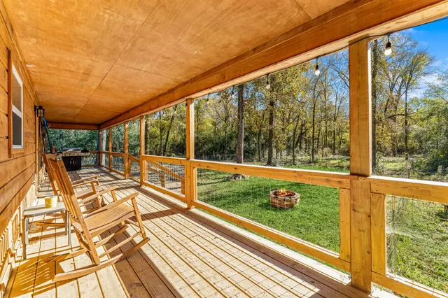 a view of a porch with wooden floor and outdoor space