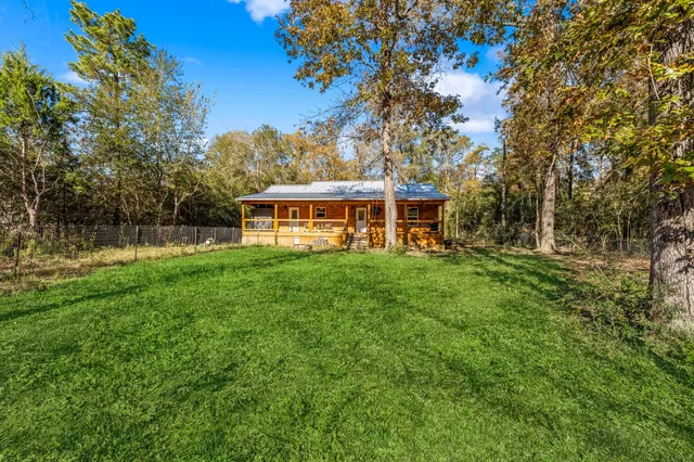 a view of an house with backyard outdoor seating and garden